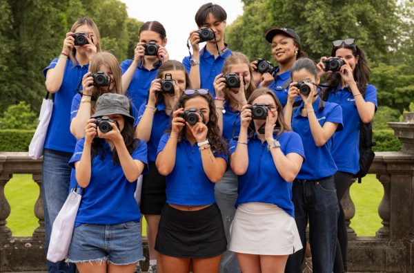 Isabelle Kitay with Canon team taking a picture with canon cameras in front of their face