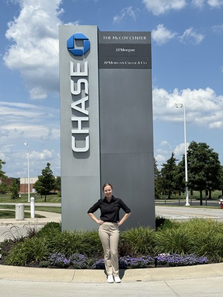 Emily Storrs standing in front of Chase sign