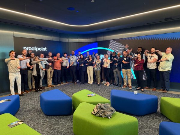 A large group of students do the Gator Chomp at Proofpoint's corporate offices.