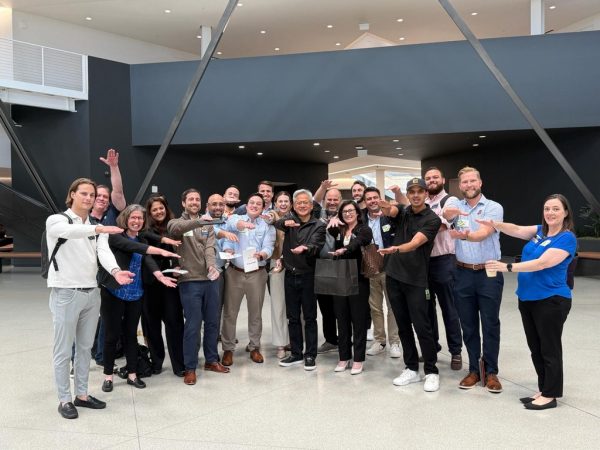 A large group of students do the Gator Chomp with Jensen Huang at Nvidia.