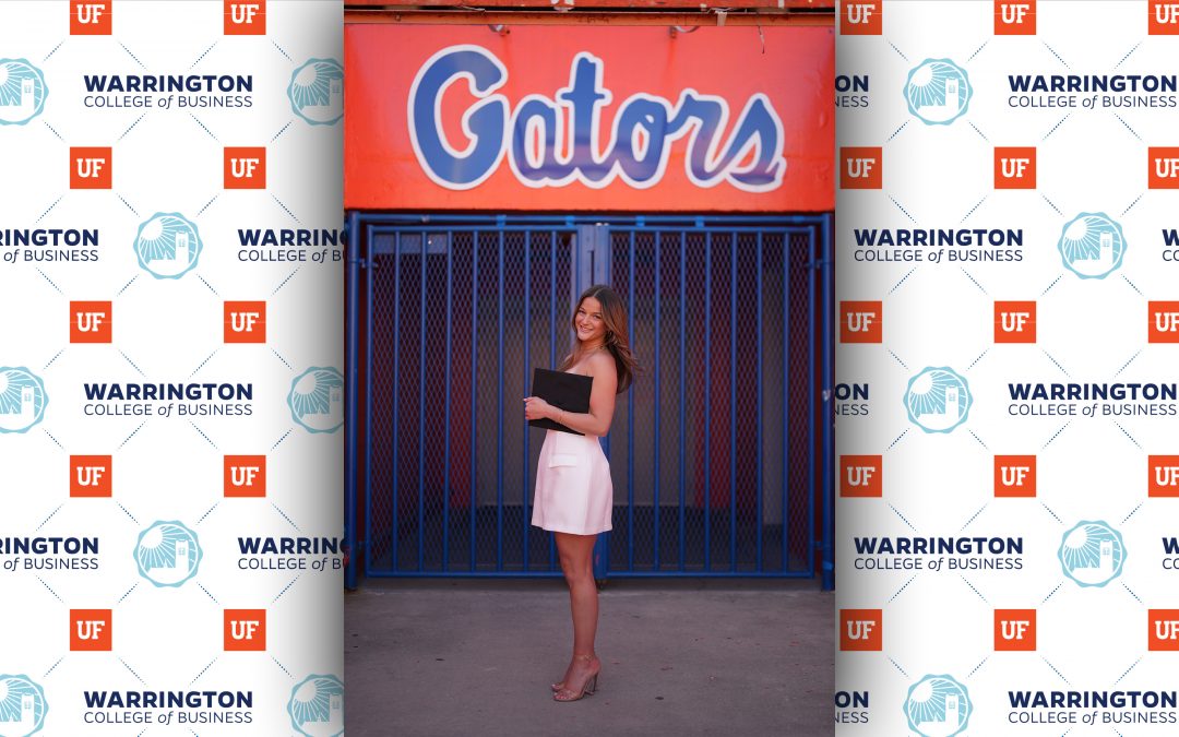grace field standing of gator sign with diploma