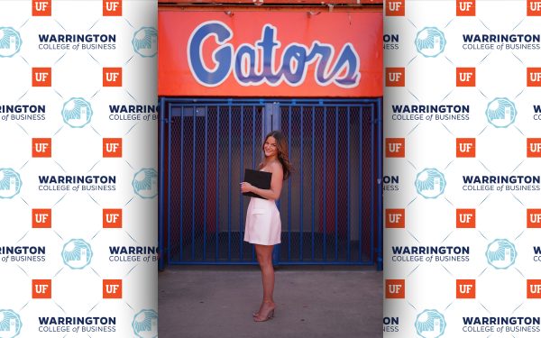 grace field standing of gator sign with diploma